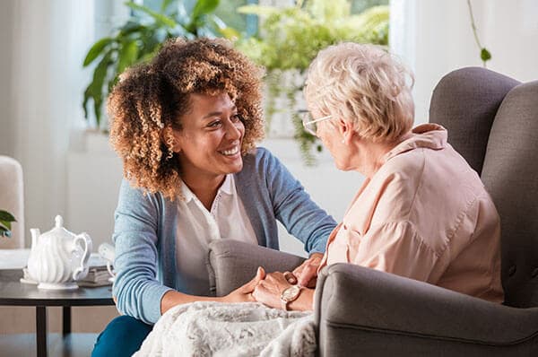 An old woman talking to her care taker