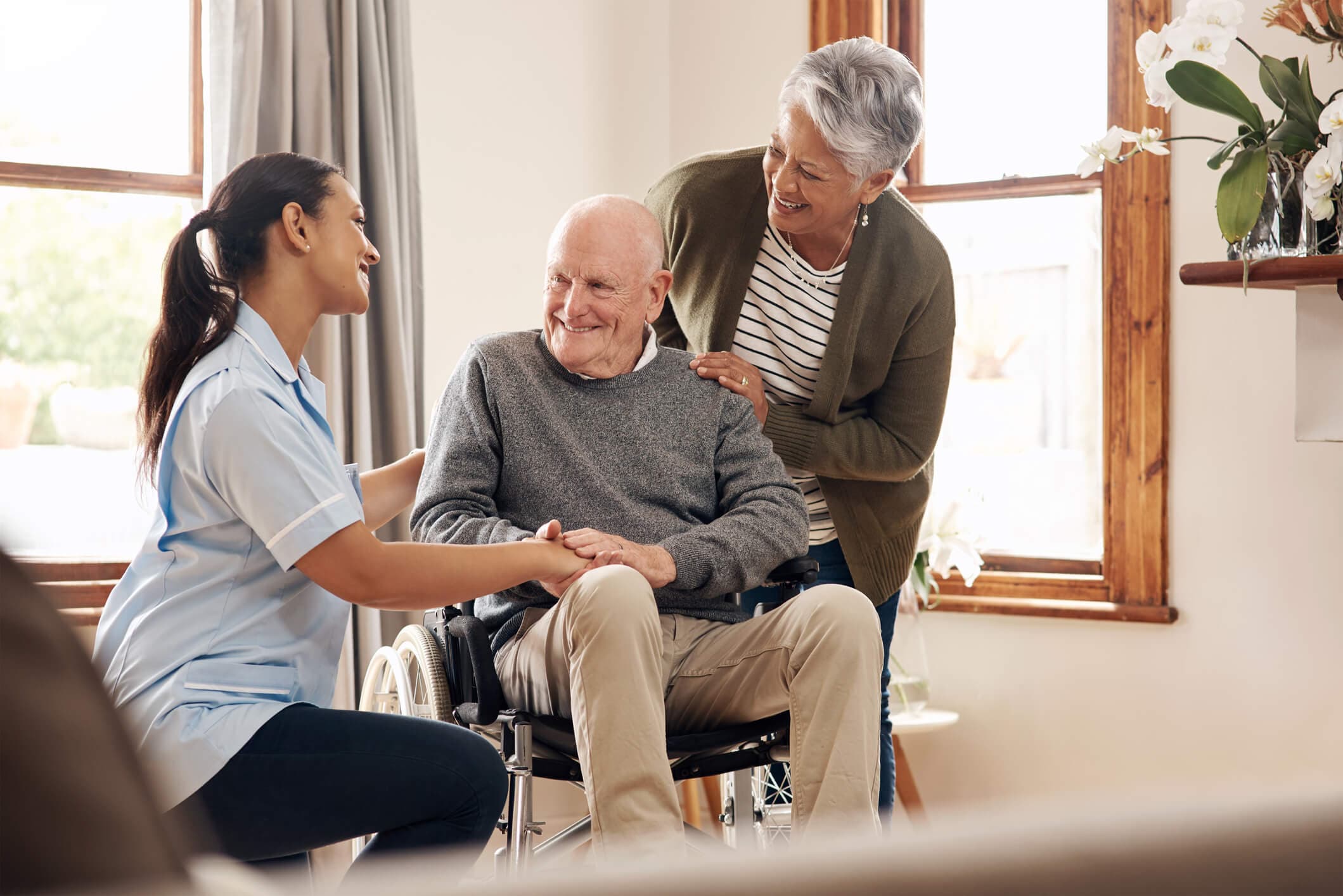 A lady talking to two seniors